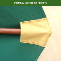 Close-up of a green fabric canopy with a wooden rib inserted into a beige leather rib pocket for added durability. The UV-treated, durable hunter green canopy of the Formosa Covers 11ft Market Patio Umbrella Double-Vented 8 Rib Replacement Canopy extends outward, and the text at the top reads 