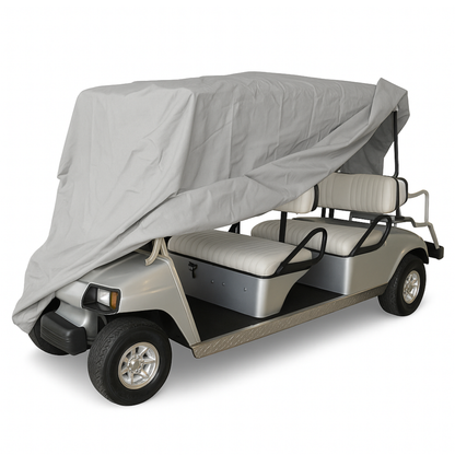 Grey 6 passenger golf cart storage cover partially draped over a silver and white golf cart with roof up