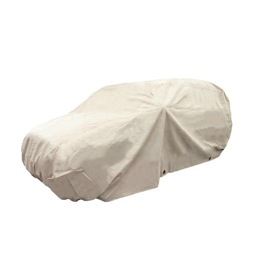 A beige, heavy-duty SUV Cover Large 200"L from Formosa Covers drapes over a vehicle, fully concealing its shape apart from the general outline. The cover is slightly wrinkled and extends down to cover all four wheels, providing excellent protection from the elements.