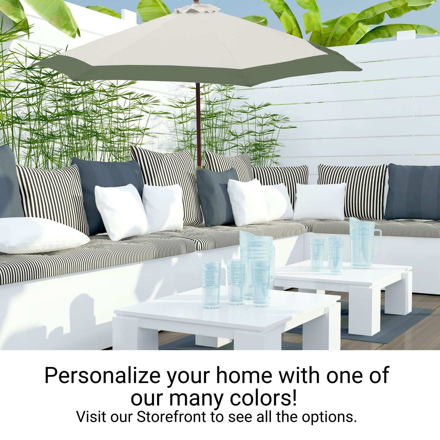 A cozy outdoor patio setup featuring a white L-shaped sectional sofa with striped and solid pillows, a large gray umbrella outfitted with the Formosa Covers 9ft Market Patio Umbrella 6 Rib Replacement Canopy in Duet Sage Green, a white coffee table with clear plastic cups, and lush green plants in the background. Text reads: "Personalize your home with one of our many colors! Visit our Storefront to see all the options.