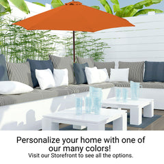 A cozy outdoor patio setup featuring water-repellent white cushioned seating adorned with striped and solid pillows, a Formosa Covers 11ft Market Patio Umbrella with an 8 Rib Replacement Canopy in Tuscan Orange providing ample shade, two white coffee tables holding clear glasses, and a backdrop of a white fence with green plants. Text encourages customization.