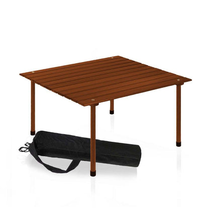 Outdoor portable wood roll up table in teak finish with black carrying case.