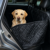 Car seat hammock cover for dogs with non-slip black fabric in car backseat.
