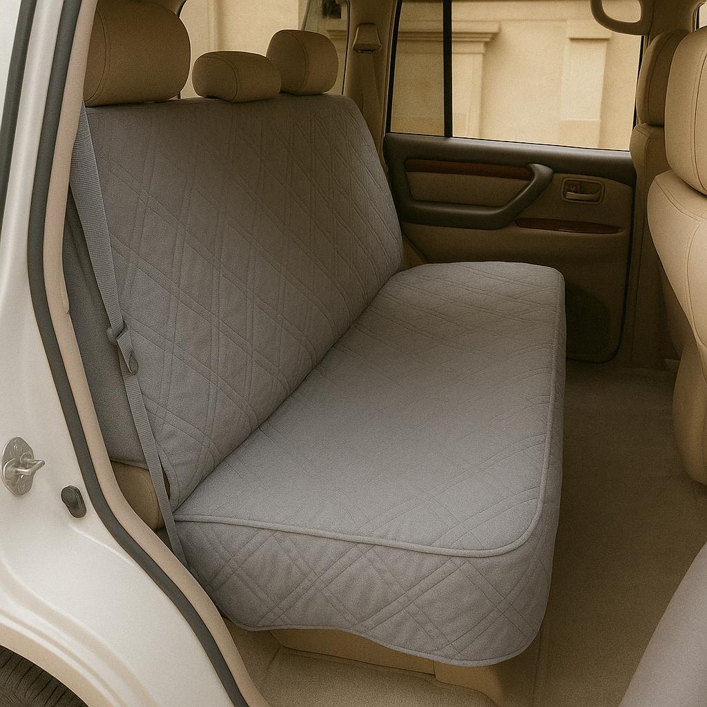 Car seat bench cover for dogs, grey, quilted and padded, installed in a car, protecting against pet hair and stains.