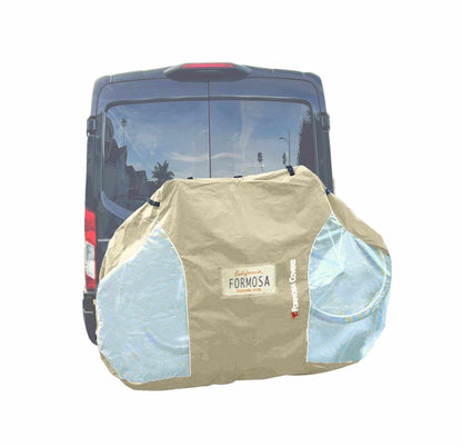 A large translucent-ended bike cover adorned with "Formosa Covers" in white and red text is securely fastened to the hitch mount bike rack on the back of a black SUV. The cover, featuring UV and water damage protection, fits 1-2 bicycles or other gear encased inside and includes a license plate holder.