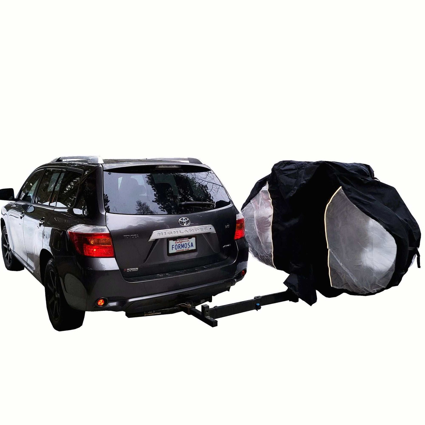 A dark-colored SUV with a Formosa Covers Lightweight Dual Bike Rack Cover For Transport (Fits 1-2 Bikes) with Large Translucent Ends attached to the rear. The lightweight carrier is protected by the black cover, which is slightly open, partially revealing several bicycles. The bike carrier is securely fastened to the vehicle's hitch.