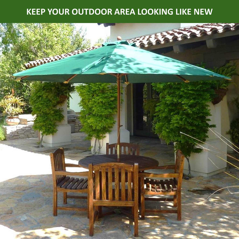 A patio area featuring a durable wooden table and chairs set under the Formosa Covers 11ft Market Patio Umbrella Double-Vented 8 Rib Replacement Canopy in Hunter Green. The patio is surrounded by lush greenery and shaded by a tiled roof. The text "KEEP YOUR OUTDOOR AREA LOOKING LIKE NEW" is displayed at the top of the image.