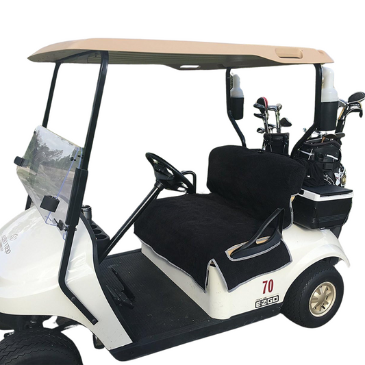 A well-maintained white golf cart featuring comfortable accessories, including a beige roof and clear windshield. It has two black cushioned seats with the Reversible Golf Cart Dual Seat Blanket Cover in black and taupe from Formosa Covers. The cart also includes a steering wheel, golf clubs stored in the back, and the number "70" printed on the side.