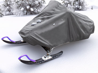 A snowmobile covered with the Formosa Covers Snowmobile Storage Cover Fit Up Length 126"-138" sits on a snow-covered landscape. The only visible parts of the snowmobile are its black skis with purple handles. Snow-dusted trees are seen in the background.