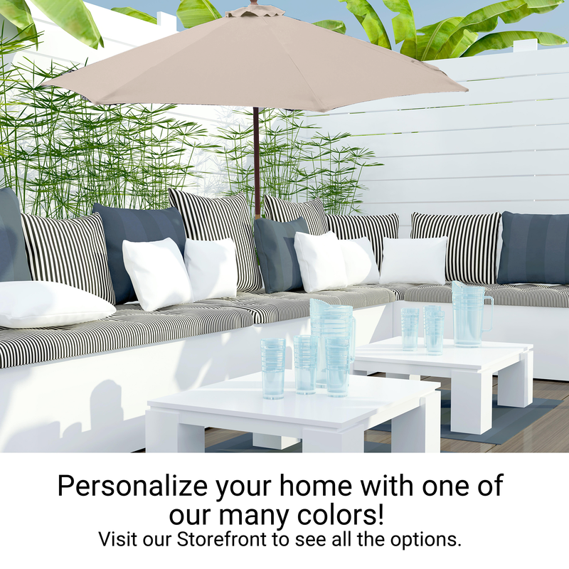 A cozy outdoor patio scene showcasing a white sectional sofa adorned with black-and-white striped cushions and white pillows. In front of it, two white tables hold clear glasses. Overhead, there's the Formosa Covers 9ft Market Patio Umbrella 6 Rib Replacement Canopy in Sand, made of durable polyester fabric. Green plants create a serene backdrop. Text reads, "Personalize your home with one of our many colors! Visit our Storefront to see all the options.”